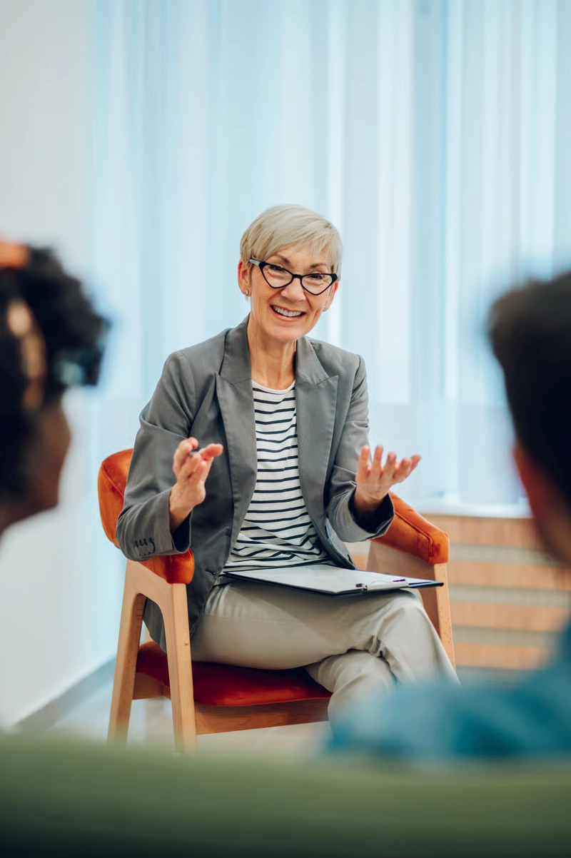 Therapist speaking with clients during a counselling session